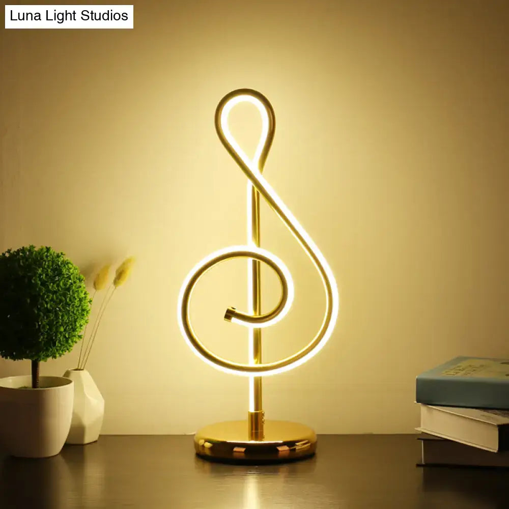 Golden neon table lamp shaped like a musical treble clef with power switch modern twist night table light from decorbites