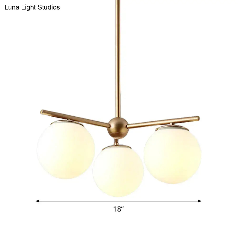 DecorBites modern gold chandelier with three white frosted glass shades for bedrooms and living spaces