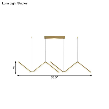 Modern gold-toned metal hanging lamp with geometric design and minimalist finish for dining room by DecorBites