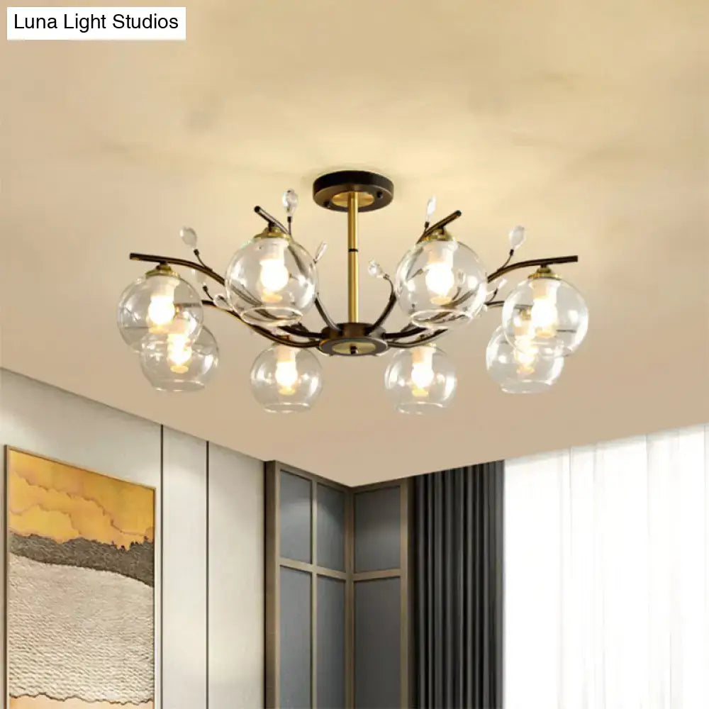 Brass-toned decorbites ceiling light with cream clear glass globes and delicate branch-like arms in black and gold