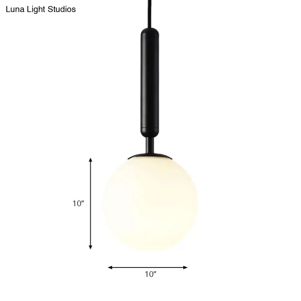 DecorBites™ modernist pendant light with white glass globe, black stem, gold finish, and 10 inches fixture size