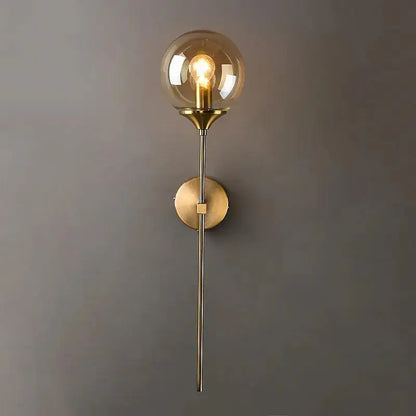 DecorBites Moroccan glass wall sconce featuring a sleek brass design with an amber glass wall globe and filament bulb