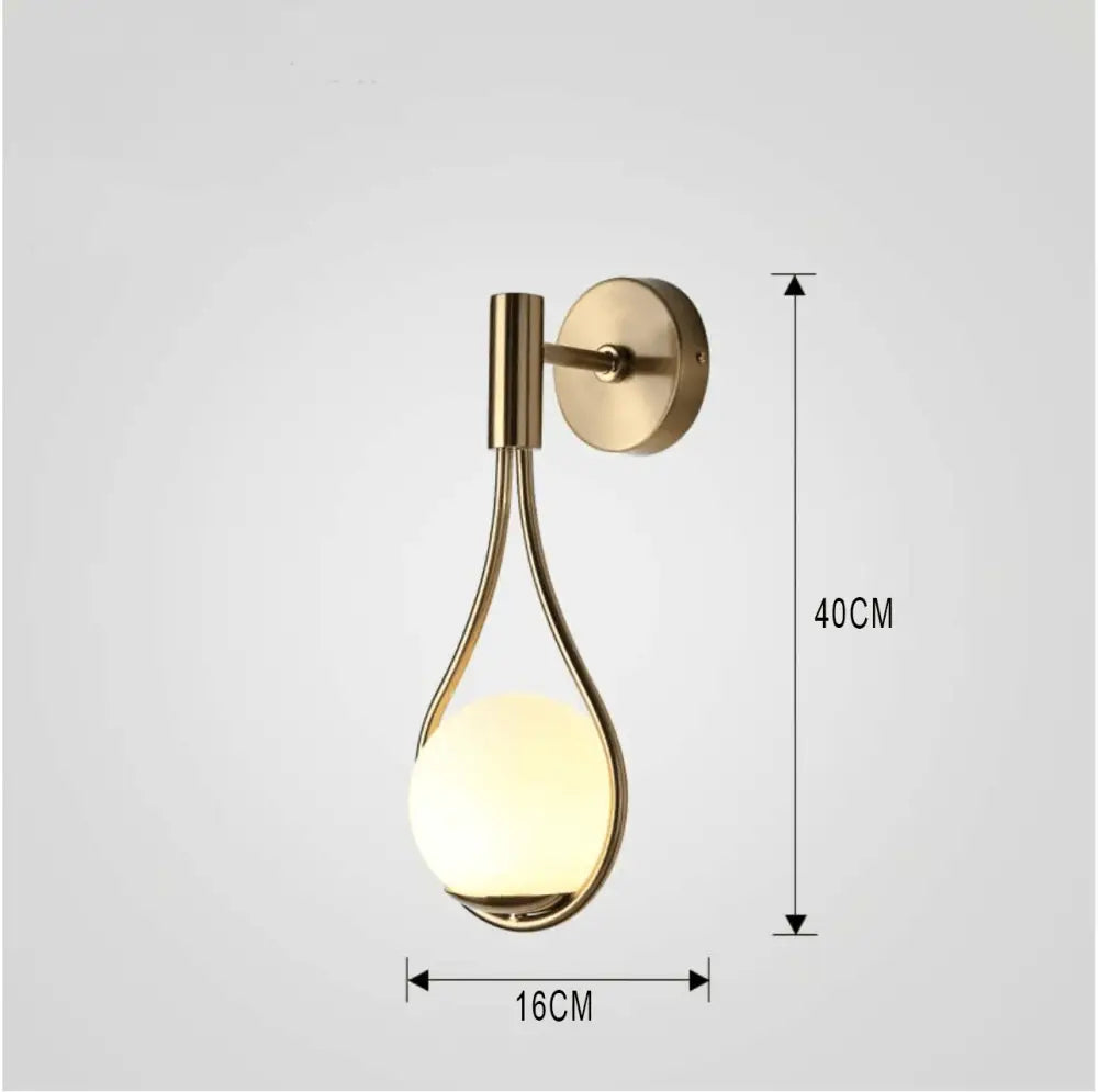 A sleek decorbites™ moroccan gold modern nordic wall lamp with a brushed brass finish and glowing frosted glass globe