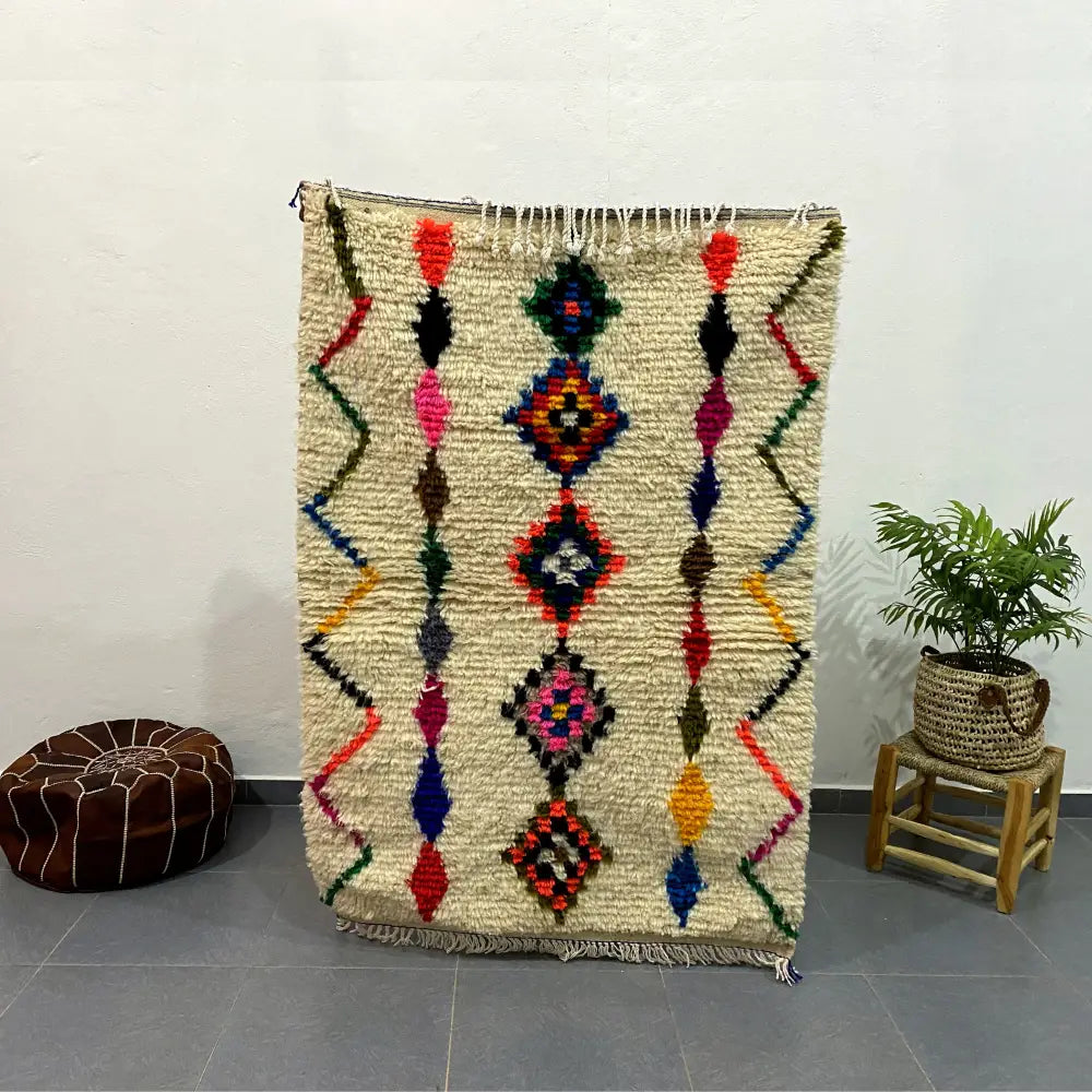 Vibrant cream-colored moroccan handmade azilal rug with geometric diamond and zigzag motifs 1.5m x 1m by DecorBites