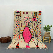 Vibrant cream-colored decorbites™ moroccan handmade azilal rug with bold pink black yellow geometric patterns and multicolored dots