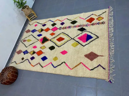 Cream-colored decorbites™ moroccan handmade azilal rug 3m x 2m with vibrant geometric patterns on wool base