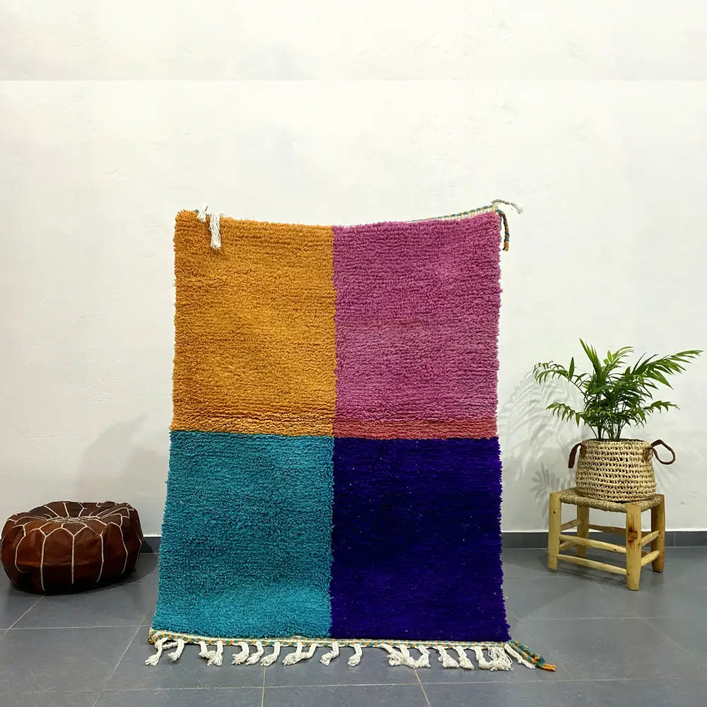 Vibrant plush moroccan handmade beni ouarain rug with color-block design in mustard yellow magenta teal and deep purple with white fringe
