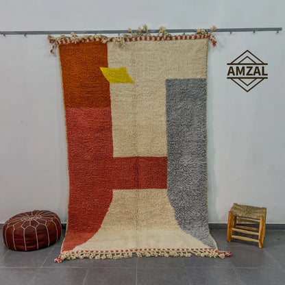 Vibrant geometric wool beni ouarain rug with bold orange, cream, and gray blocks and yellow triangle accent