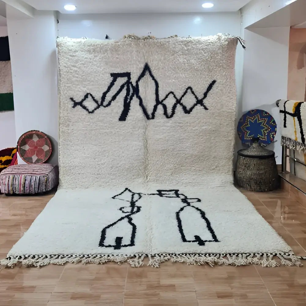 Cream-colored moroccan handmade beni ouarain rug with black geometric designs and fringed edge 3m x 2m by DecorBites