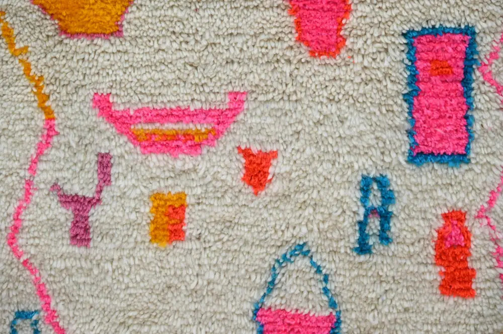 A plush off-white moroccan handmade azilal hallway rug with bright pink orange and blue abstract shapes 312 x 84 cm