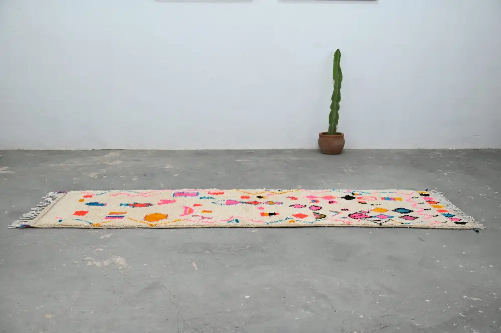 Beige moroccan handmade azilal hallway rug with colorful geometric and floral patterns and fringed edges by decorbites