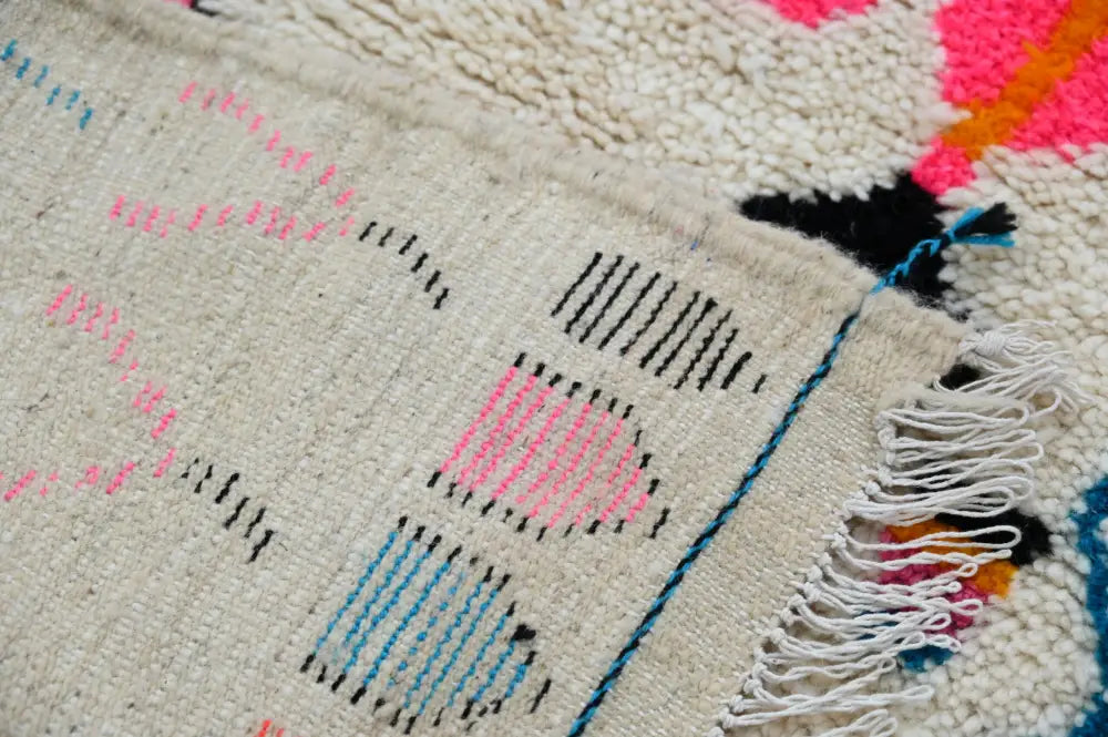 Beige woven moroccan handmade azilal hallway rug with vibrant pink blue black geometric patterns and fringed edge