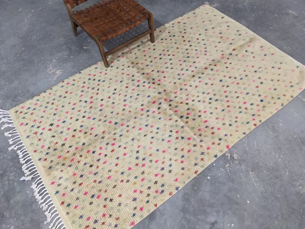 Beige moroccan handmade azilal rug with multicolored star patterns and white fringe made of pure natural wool