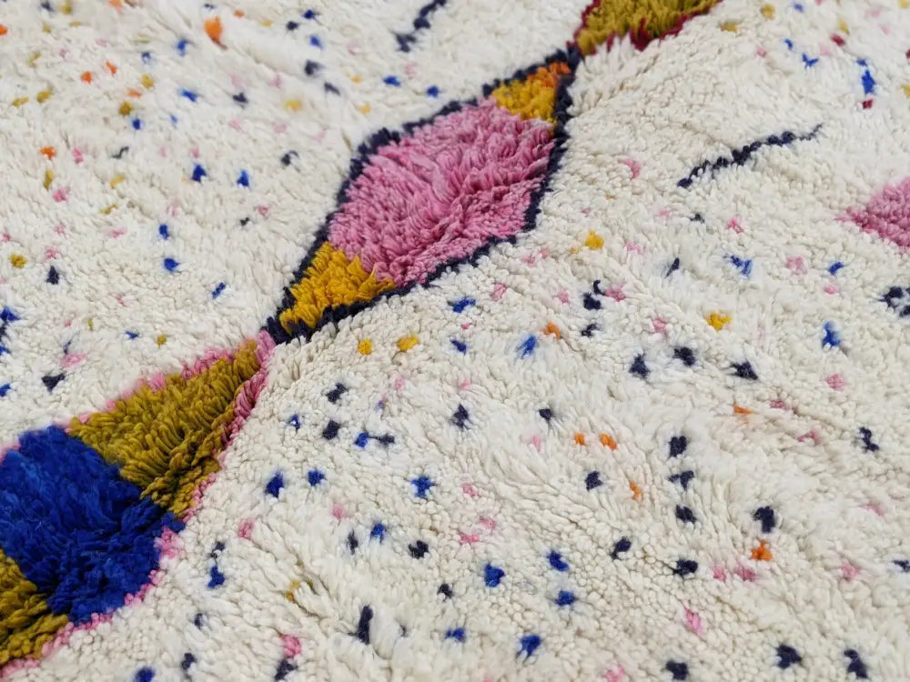 Decorbites moroccan handmade traditional azilal rug in off-white with bold pink yellow and blue geometric patterns