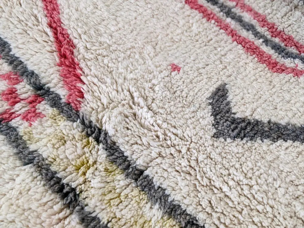 Cream-colored plush wool moroccan handmade traditional azilal rug with bold red gray and muted yellow geometric patterns