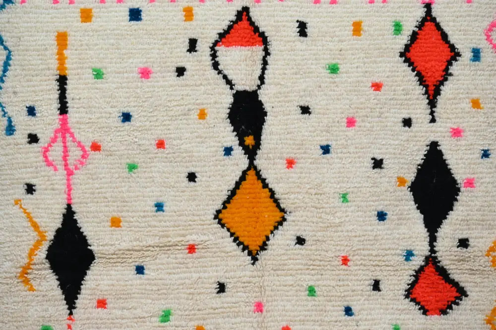 DecorBites™ moroccan handmade traditional azilal rug with bold black red orange and pink geometric patterns on off-white