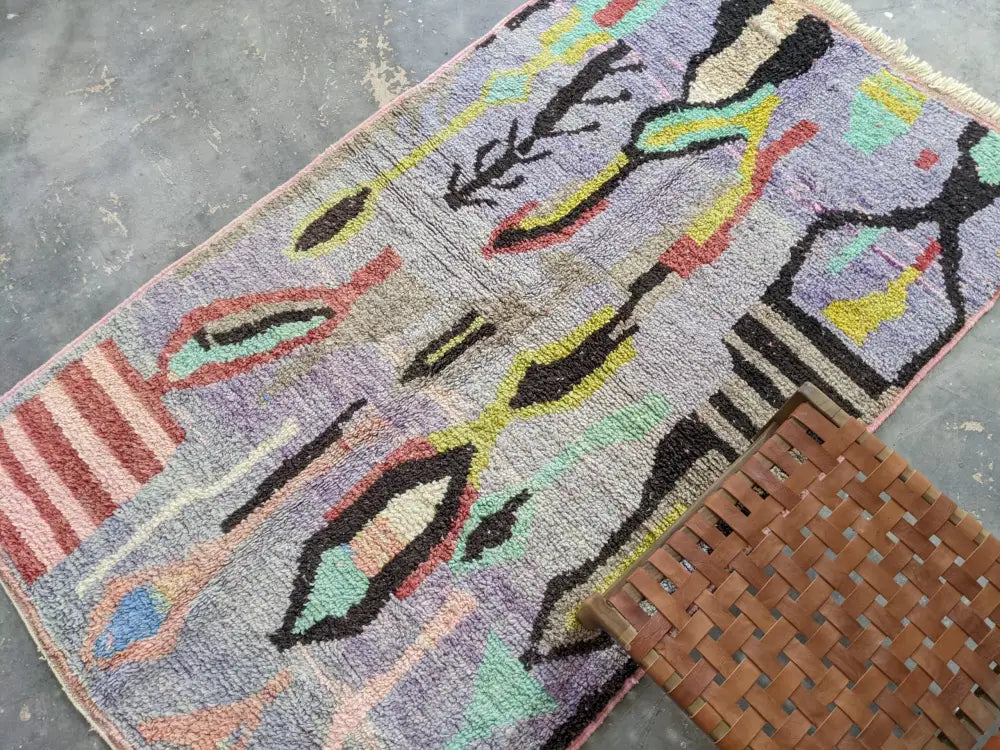 Vibrant moroccan handmade azilal rug in purple black red and teal with bold geometric patterns in pure natural wool