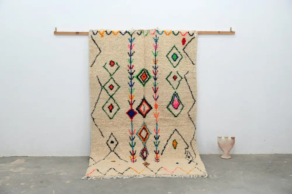 Beige moroccan handmade traditional azilal rug with colorful geometric patterns on textured woolen surface 253 x 154 cm