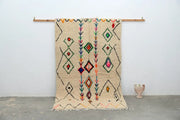 Beige moroccan handmade traditional azilal rug with colorful geometric patterns on textured woolen surface 253 x 154 cm