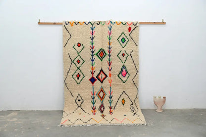 Beige moroccan handmade traditional azilal rug with colorful geometric patterns on textured woolen surface 253 x 154 cm