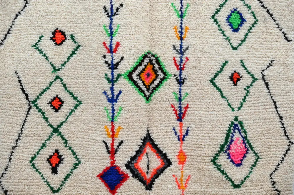 Beige moroccan handmade traditional azilal rug with vibrant green red blue and orange geometric patterns by decorbites