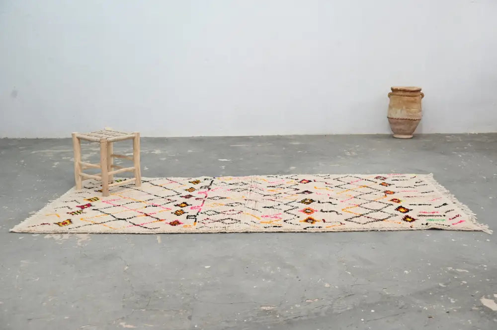 Beige moroccan handmade traditional azilal rug with pink orange black and green geometric floral patterns 258 x 120 cm