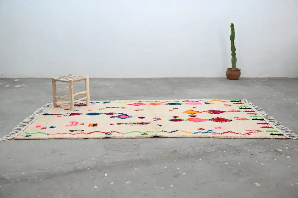 Beige moroccan handmade traditional azilal rug with colorful geometric patterns and fringed edges 262 x 142 cm