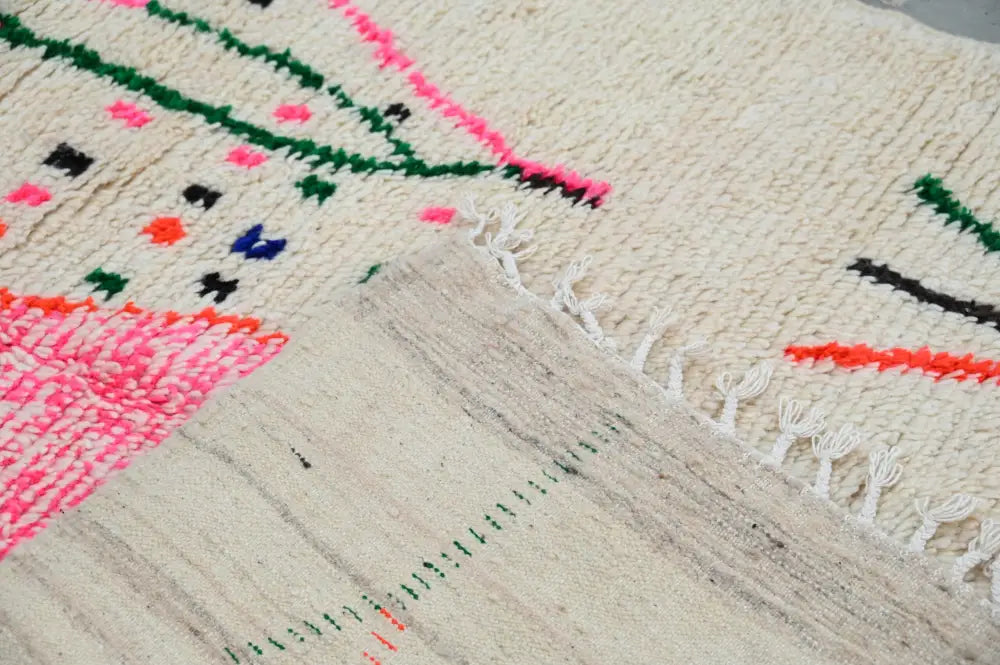 Beige moroccan handmade traditional azilal rug with vibrant pink green and orange geometric woolen patterns 268 x 157 cm