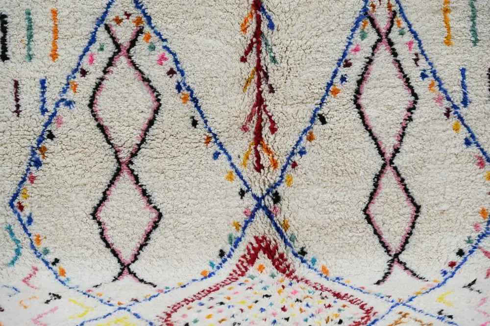 Cream-colored DecorBites™ moroccan handmade traditional azilal rug with intricate black blue pink and red geometric patterns