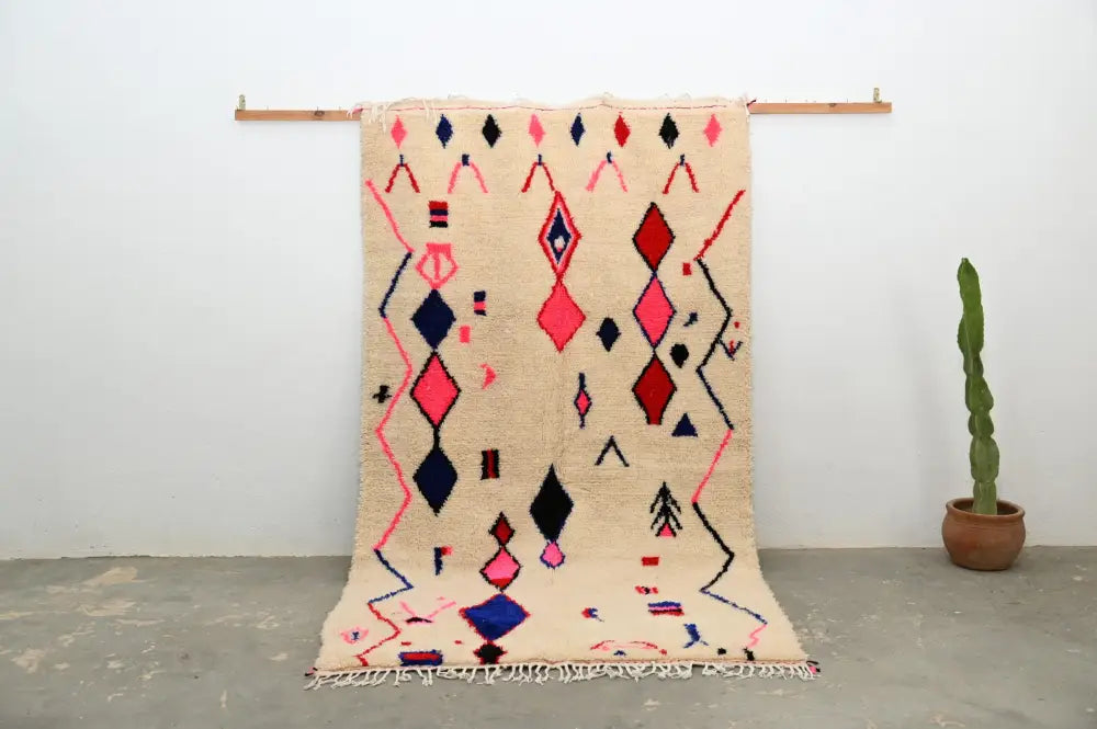 Beige moroccan handmade traditional azilal rug with pink navy blue and red geometric diamond and zigzag patterns