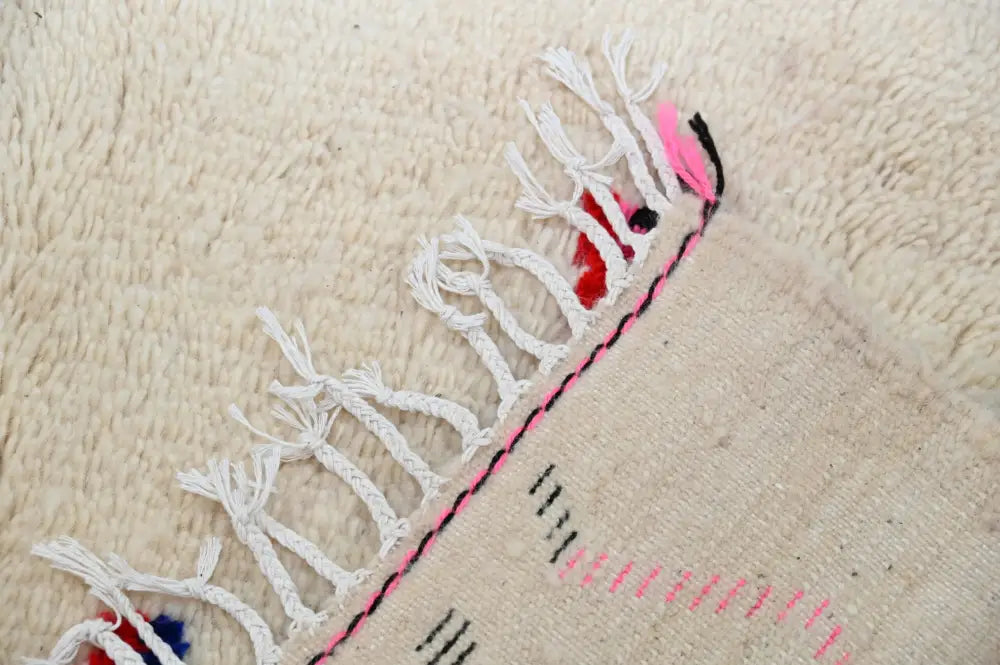 Beige woven decorbites moroccan handmade traditional azilal rug with white fringe and pink black embroidered border