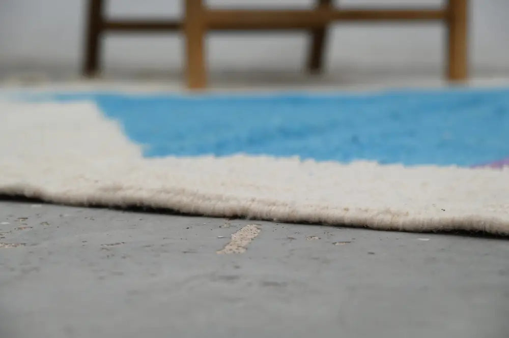 A plush white and blue moroccan handmade traditional azilal rug with a soft textured surface by decorbites