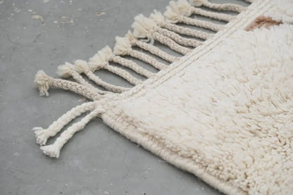 Cream-colored plush wool beni ouarain moroccan handmade rug with textured surface and tasseled fringe 283 x 211 cm