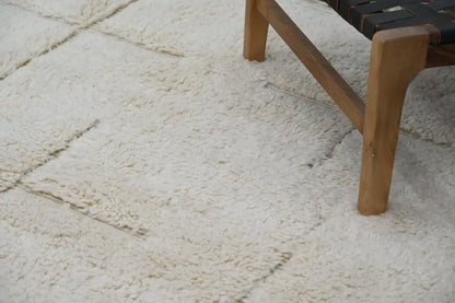 Cream-colored plush shaggy beni ouarain carpet with textured fluffy surface and visible seams moroccan handmade 300 x 205 cm