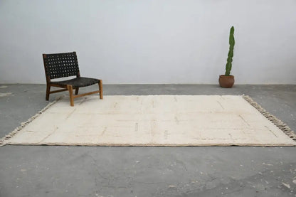 Cream-colored beni ouarain carpet with minimalist geometric pattern handwoven from wool moroccan handmade rug
