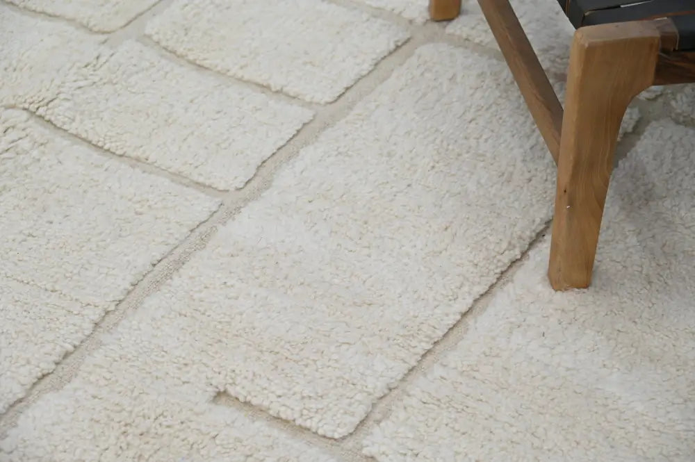 Cream-colored plush moroccan handmade beni ouarain carpet with soft textured surface and rectangular sections 305 x 202 cm
