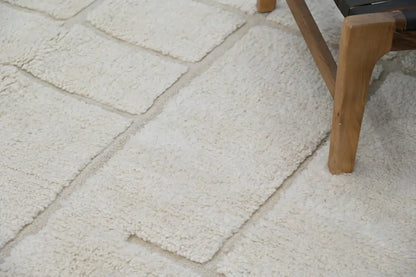 Cream-colored plush moroccan handmade beni ouarain carpet with soft textured surface and rectangular sections 305 x 202 cm