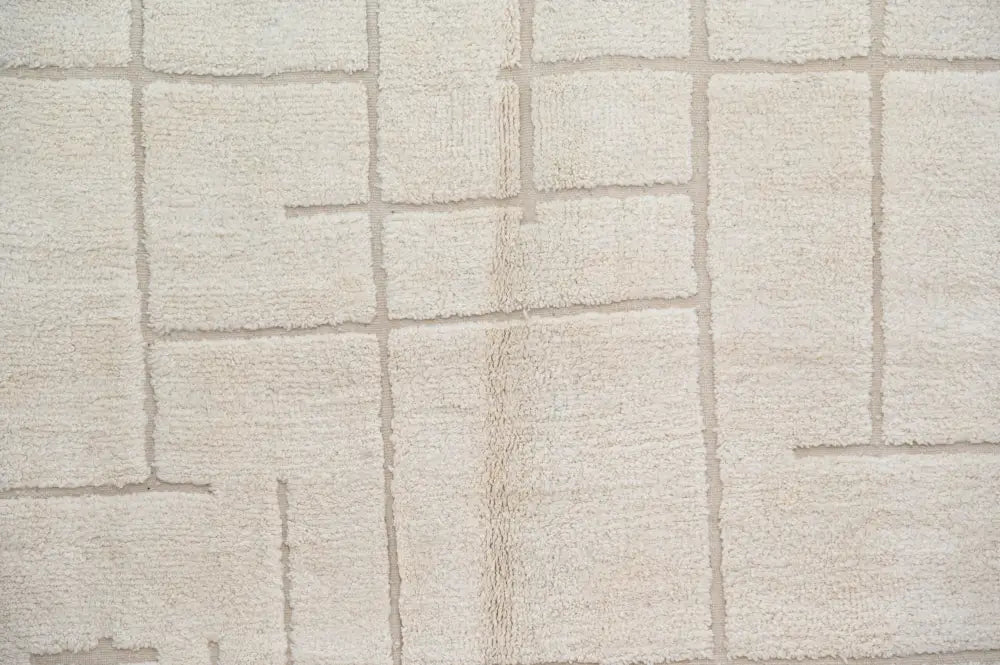 Beige textured moroccan handmade beni ouarain carpet with raised rectangular grid pattern 305 x 202 cm by decorbites