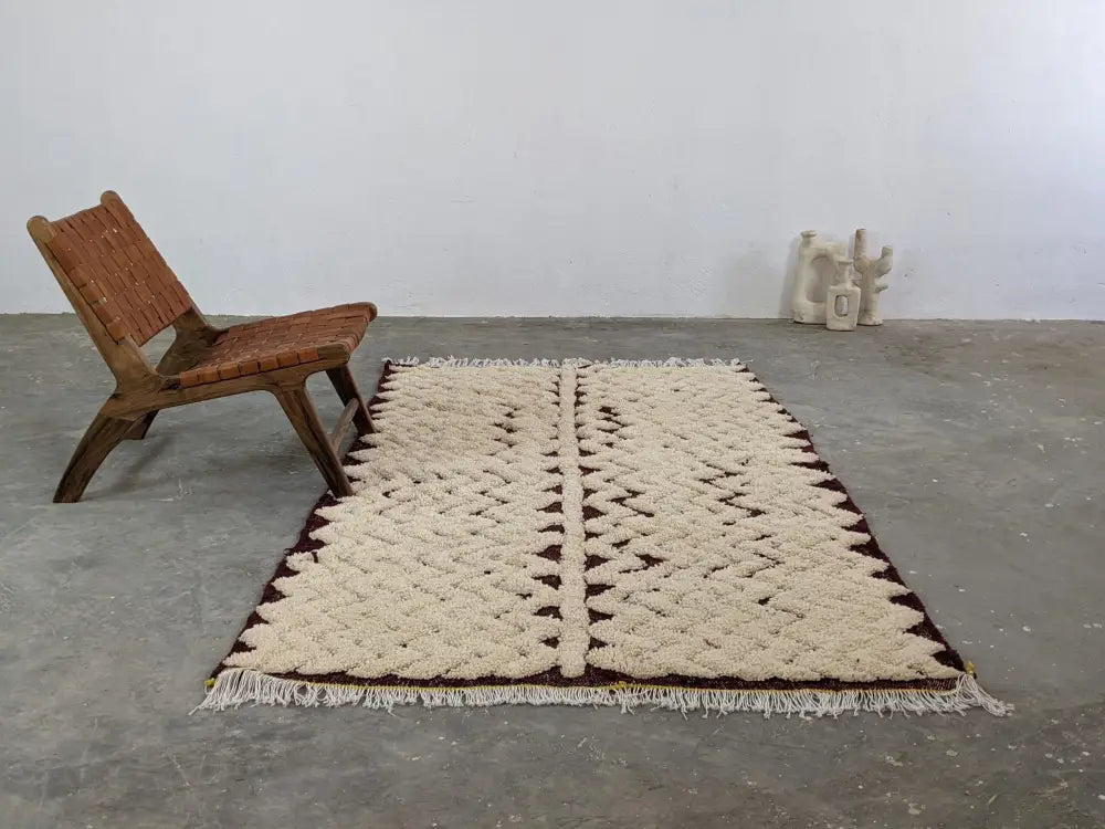 Cream-colored moroccan handmade beni ouarain rug with geometric pattern and dark brown border 252 x 137 cm by DecorBites