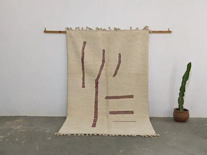 Beige woven moroccan handmade beni ouarain rug with rust geometric patterns and fringed edges 258 x 164 cm