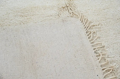 Cream-colored textured wool beni ouarain rug with plush fringe moroccan handmade traditional beni ouarain rug