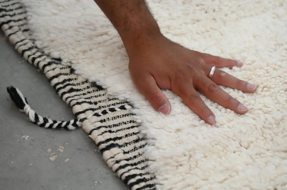Plush white beni ouarain rug with bold black and white striped fringe moroccan handmade traditional design