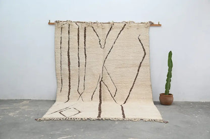 Beige beni ouarain rug with dark brown geometric patterns and fringed edges from decorbites™ handmade collection