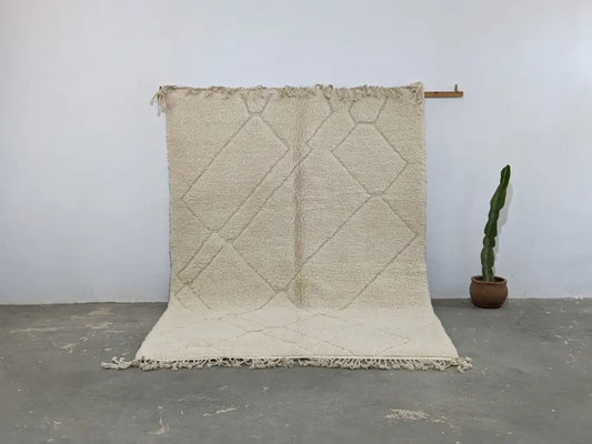 Cream-colored moroccan handmade beni ouarain rug with a textured surface and geometric diamond pattern 295 x 214 cm