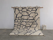 Beige and navy blue geometric patterned moroccan handmade beni ouarain wool rug with fringed edges 297 x 208 cm