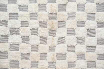 A beni ouarain rug by decorbites featuring a soft cream and gray checkerboard pattern in 300 x 203 cm size
