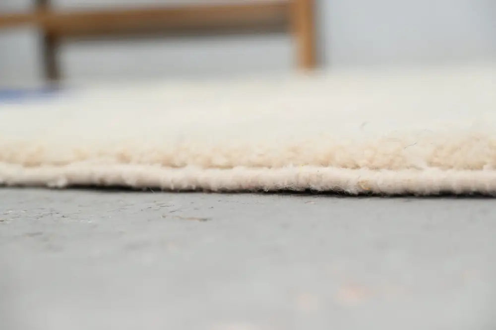 Cream-colored plush shaggy beni ouarain rug with soft textured surface and neatly finished edge moroccan handmade