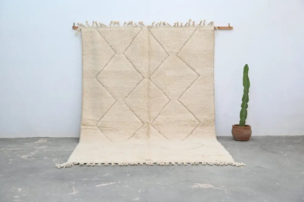 Beige moroccan handmade beni ouarain rug with diamond pattern and fringed edges 300 x 212 cm by decorbites