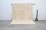 Beige moroccan handmade beni ouarain rug with diamond pattern and fringed edges 300 x 212 cm by decorbites