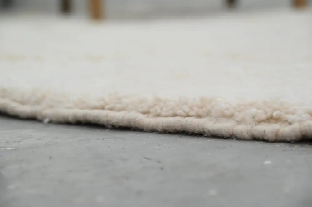 Cream-colored moroccan handmade beni ouarain rug with plush wool and soft textured edge 302 x 200 cm by DecorBites